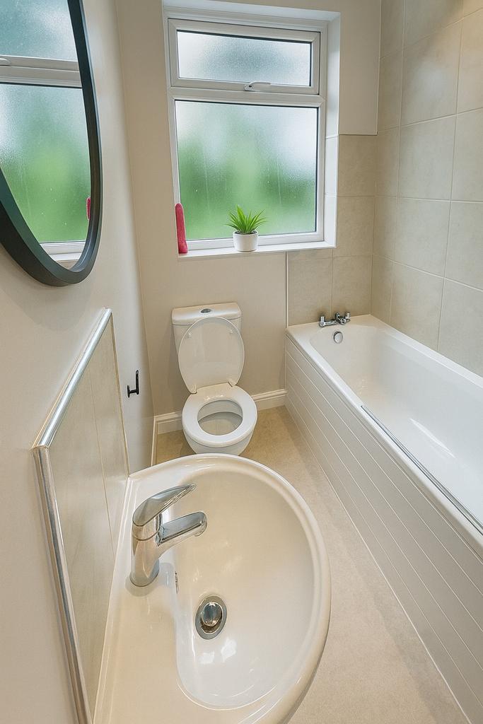 Bright and tidy bathroom featuring a modern bat...