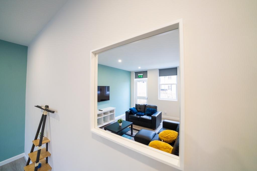 A modern, bright living room featuring comforta...
