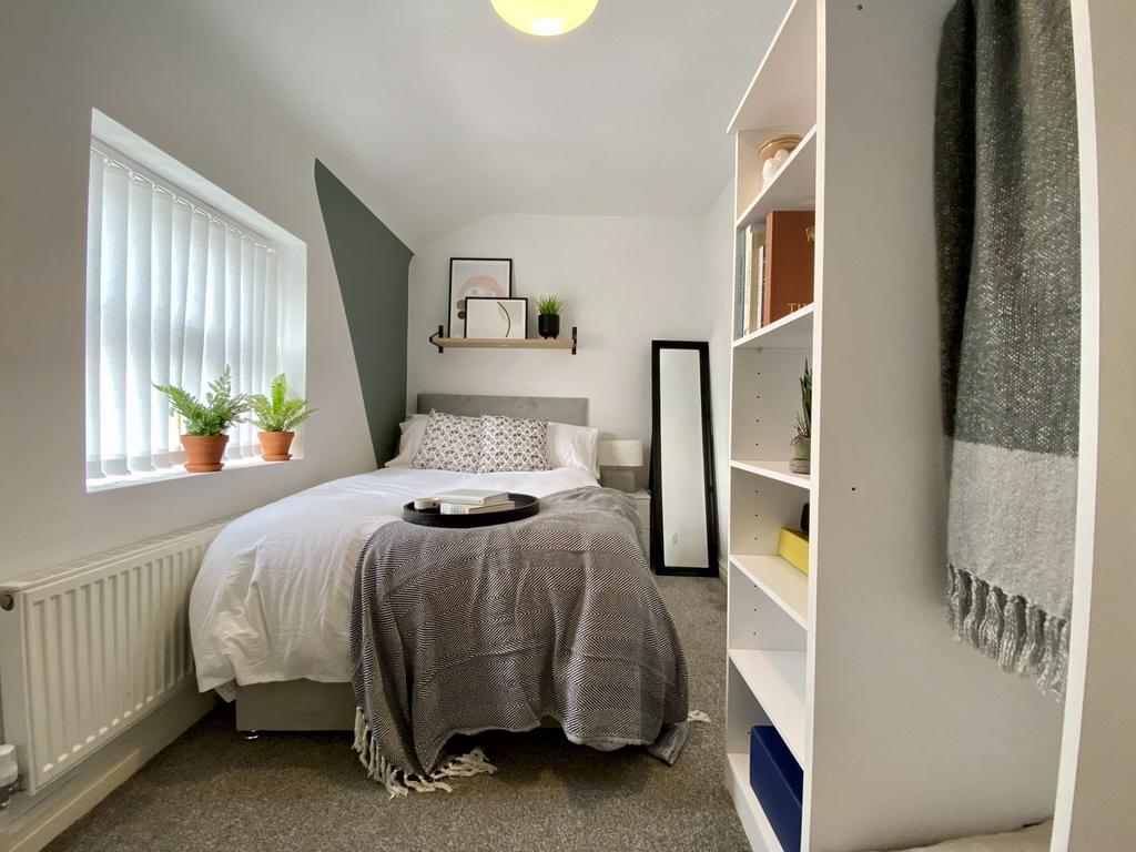 A stylish and well-lit double bedroom featuring...