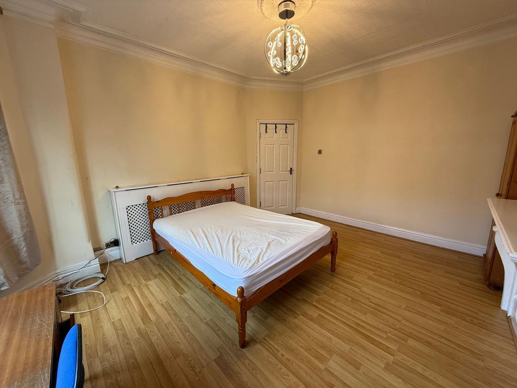 Bright, well-presented bedroom with wooden floo...