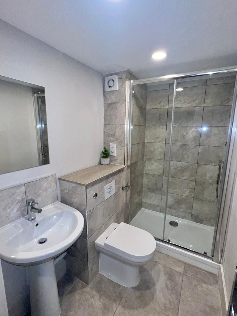 Modern tiled bathroom with a walk-in shower wit...