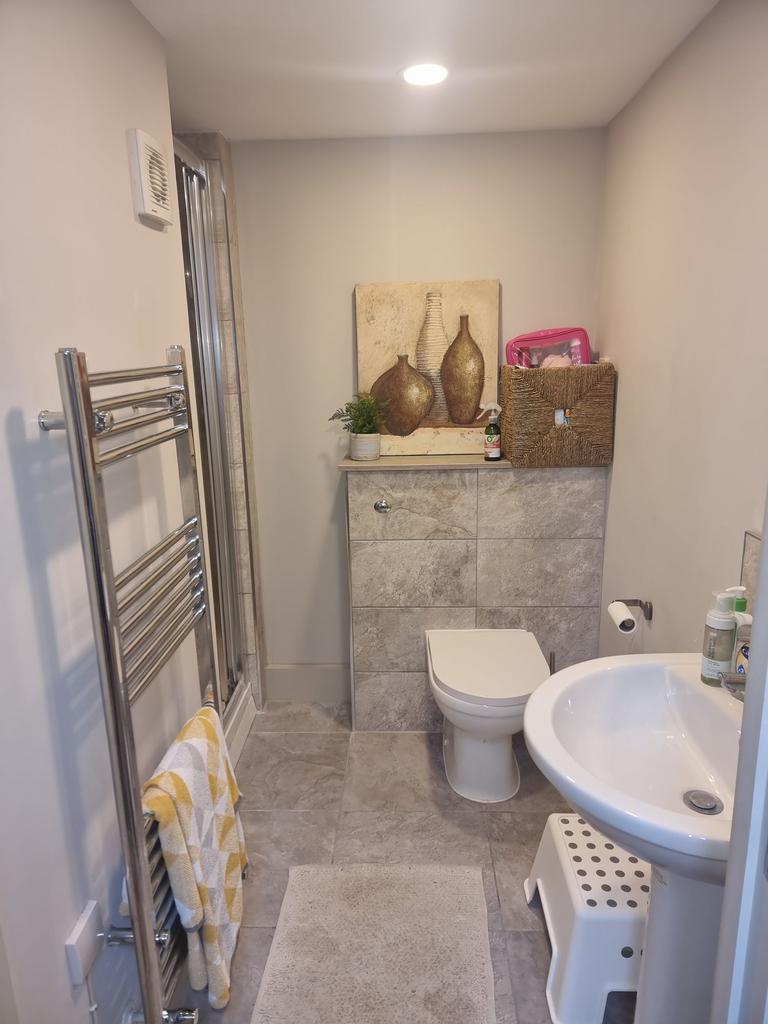 Well-maintained bathroom with modern tile finis...