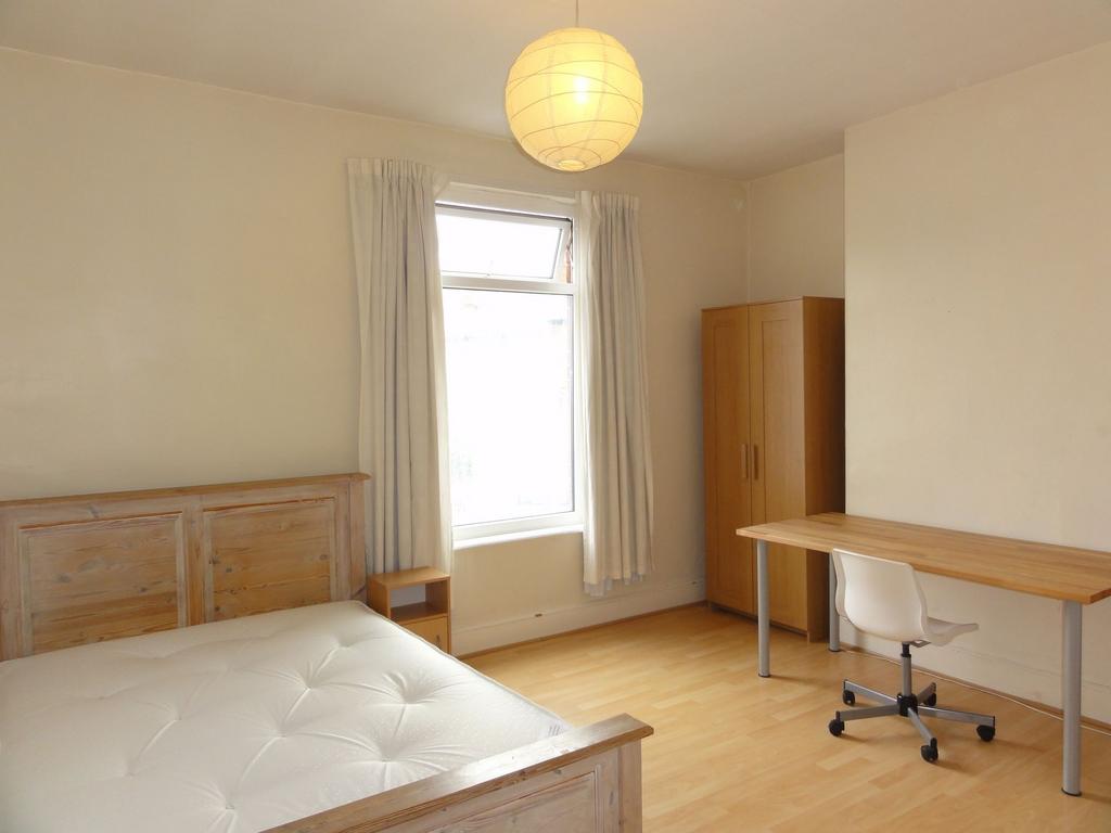Bright, neutrally decorated double bedroom with...