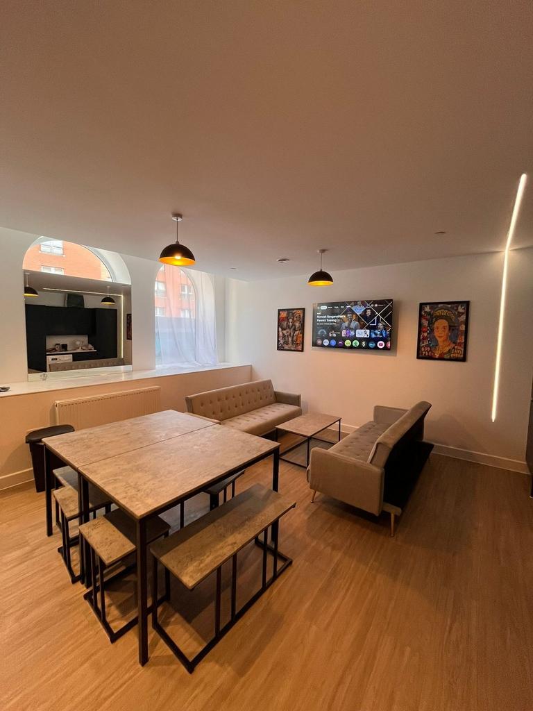 Bright, modern communal lounge with two tufted ...
