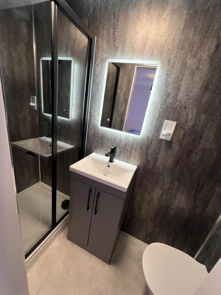 Modern compact bathroom with a sleek sink cabin...