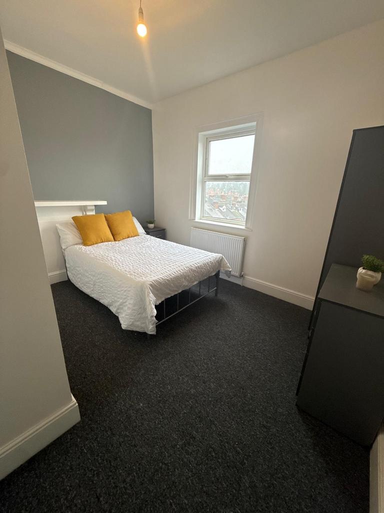 Bright, neatly presented bedroom with a double ...