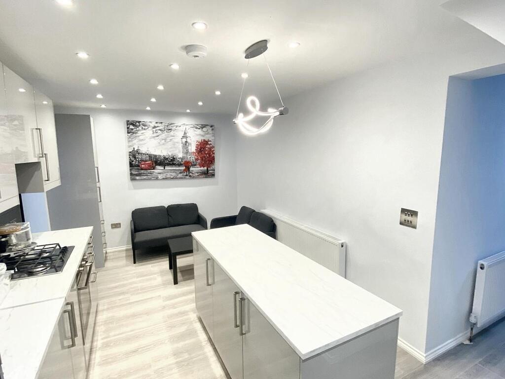 Bright modern kitchen with a central island, in...