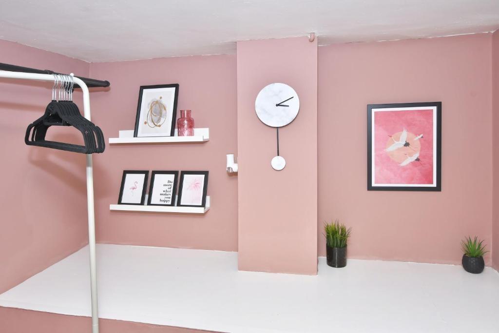 Neatly presented alcove with soft pink walls, d...