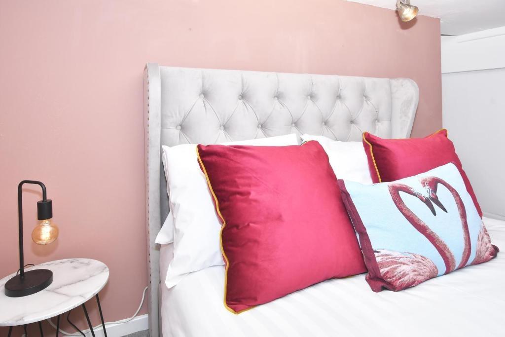 Bright, stylish bedroom with a plush tufted hea...