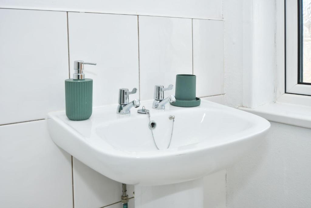 Bright, well-maintained bathroom sink with mode...