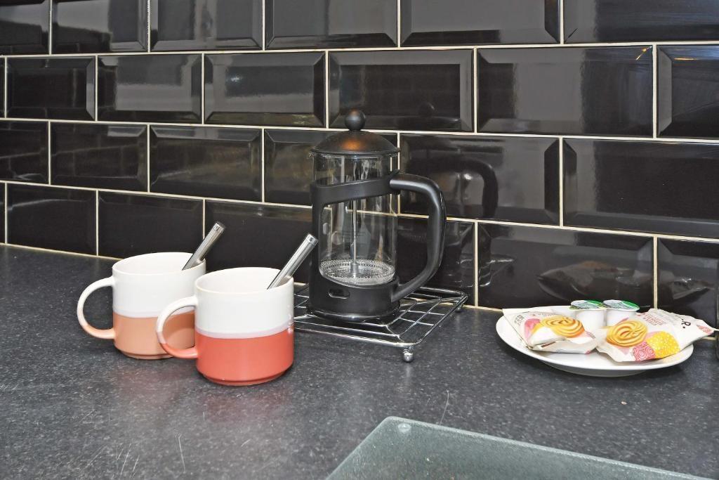 Contemporary kitchen counter with glossy subway...