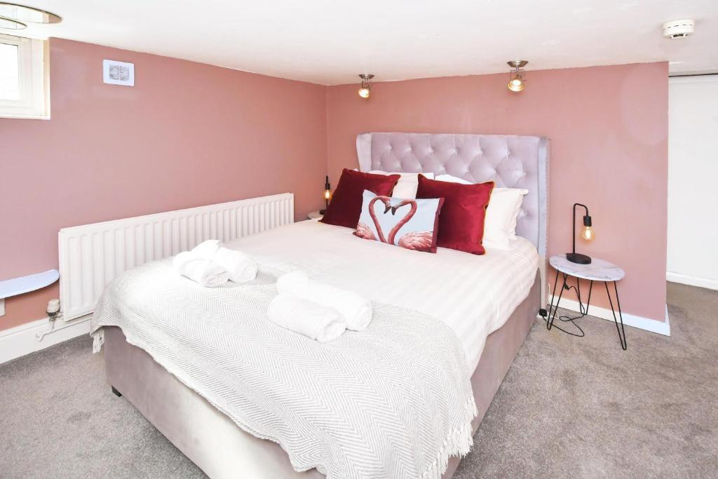 Bright, cozy bedroom with a plush upholstered h...