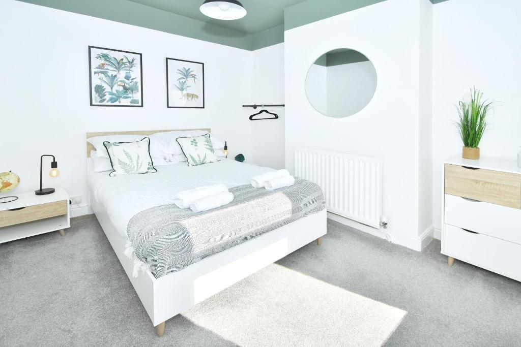 Bright, modern double bedroom with a neatly mad...