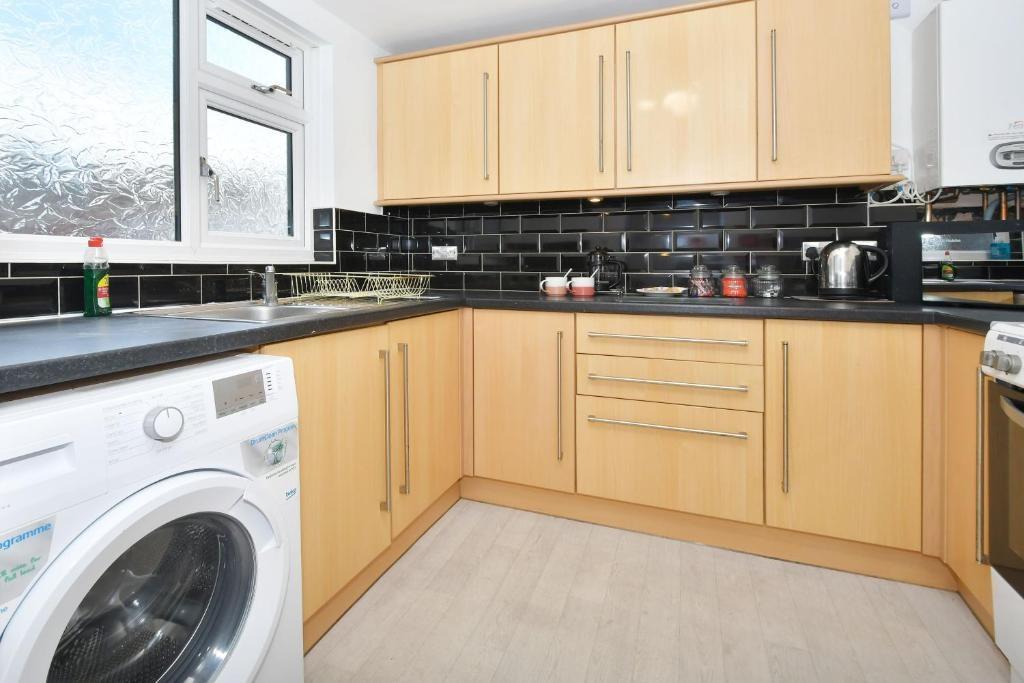 Modern fitted kitchen with light wood cabinetry...