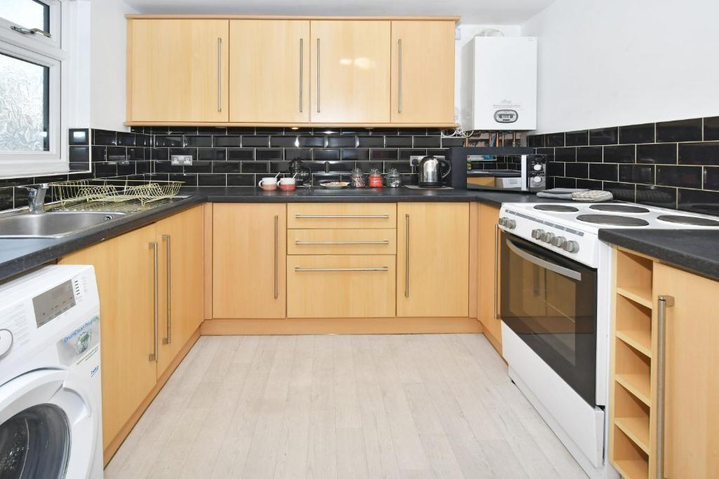 Bright, modern kitchen with light wood cabinets...