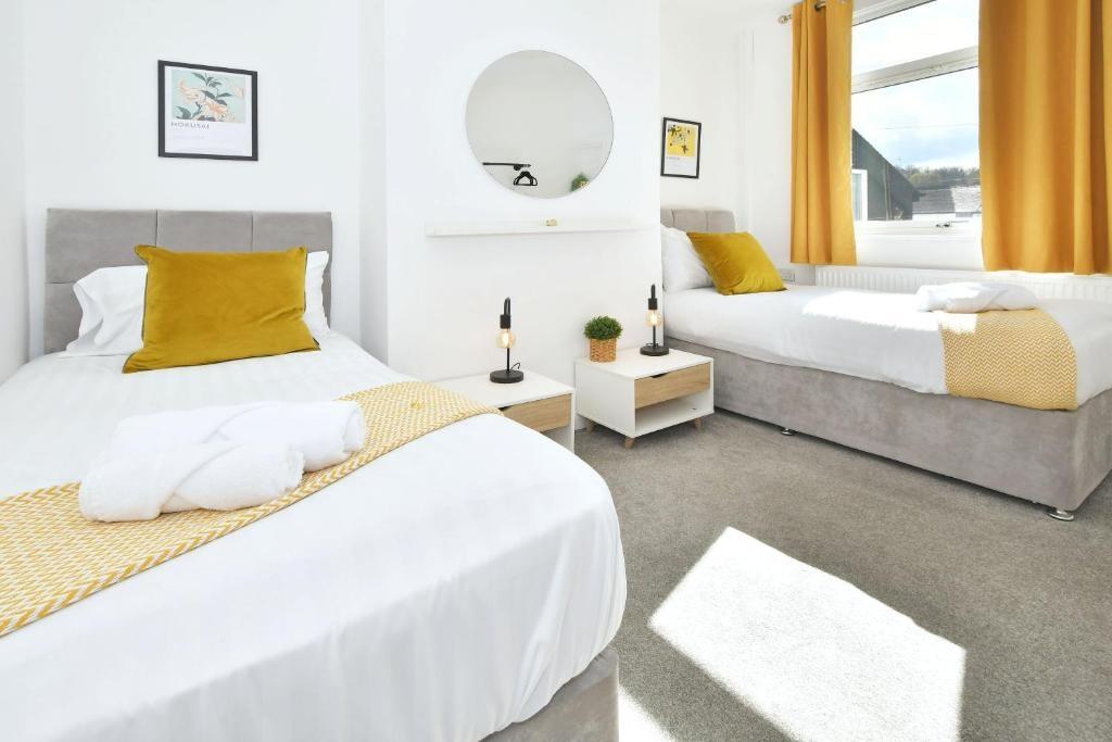 Bright, freshly styled twin bedroom with two pl...