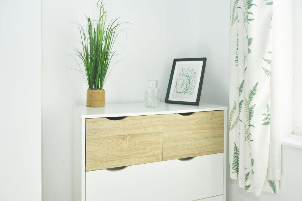Bright, minimal bedroom corner with a modern wh...