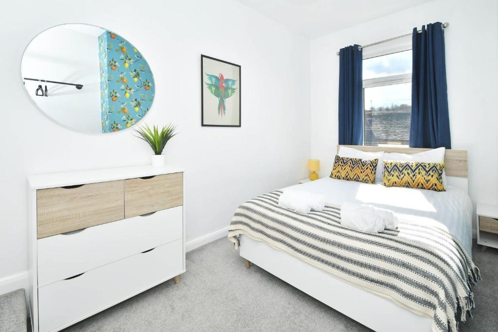 Bright, modern double bedroom with a neatly mad...