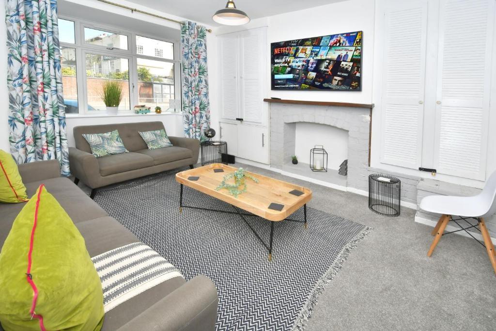 Bright, modern living room with large window, m...