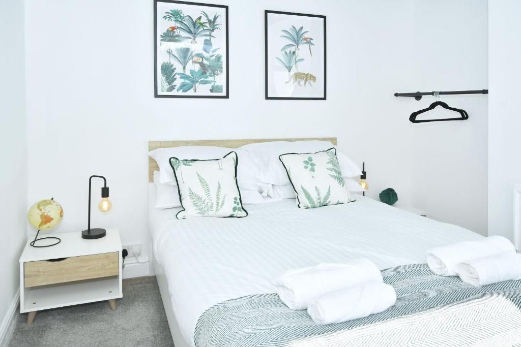 Bright, modern double bedroom with a neatly mad...