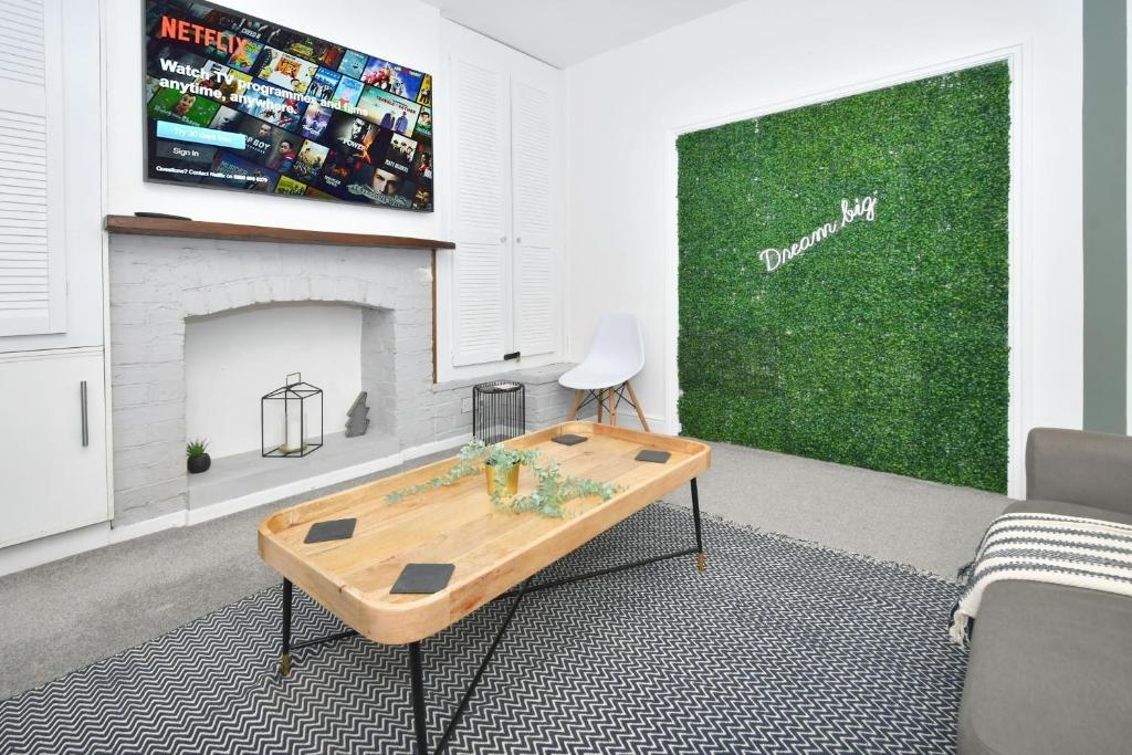 Bright, modern living room with a mounted TV ab...