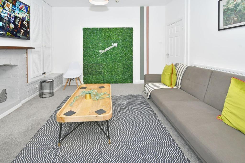 Bright, modern living room with a large sofa, d...