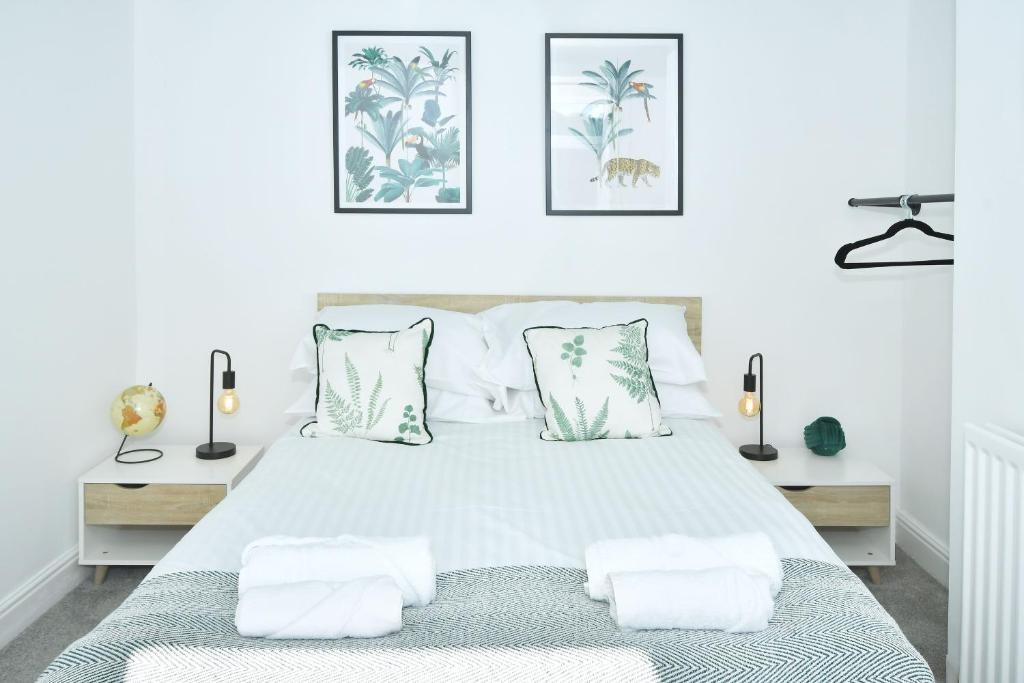 Bright, modern double bedroom with a neatly mad...