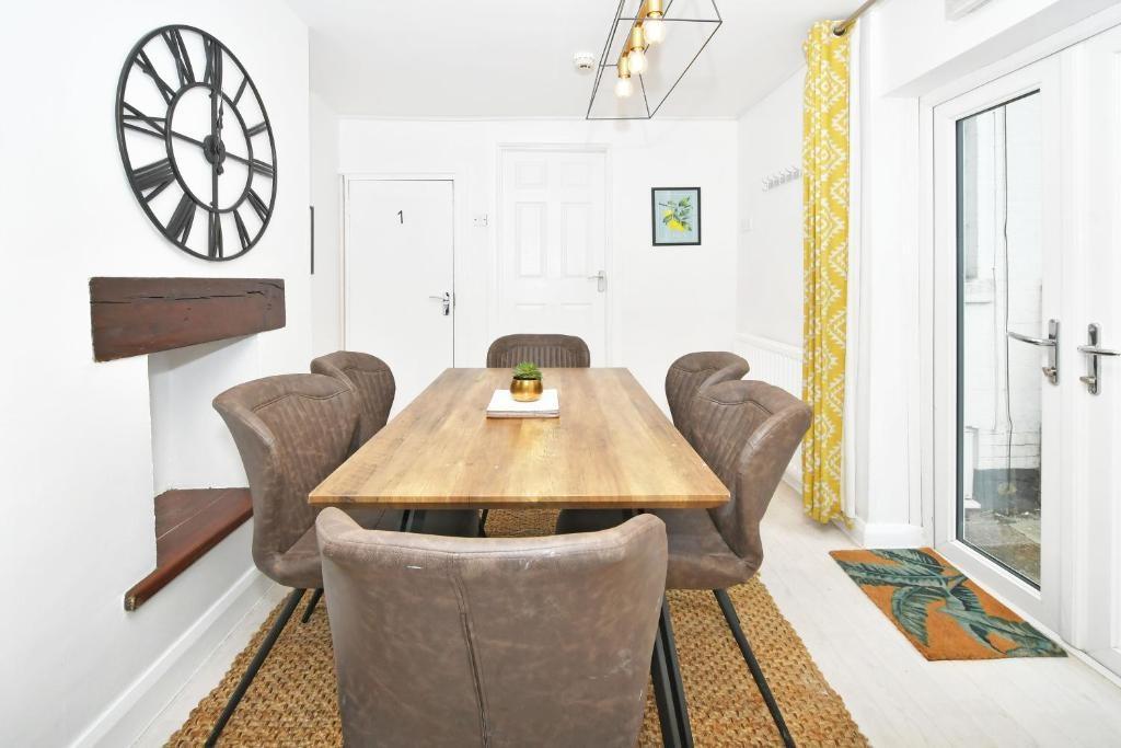 Bright, modern dining area with a solid wood ta...