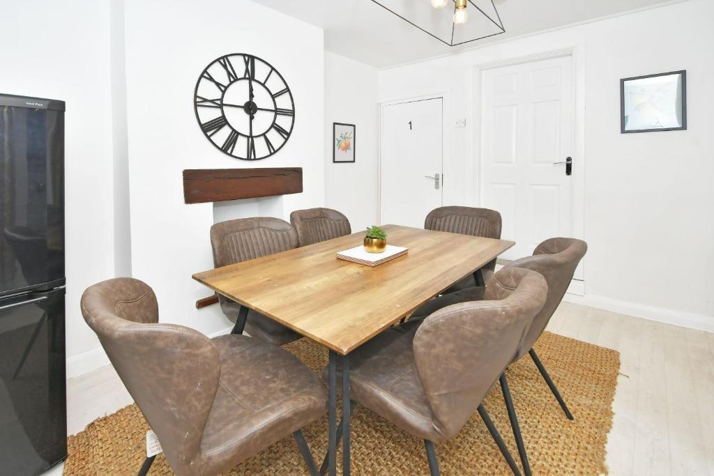 Bright, modern dining area with a wooden table ...