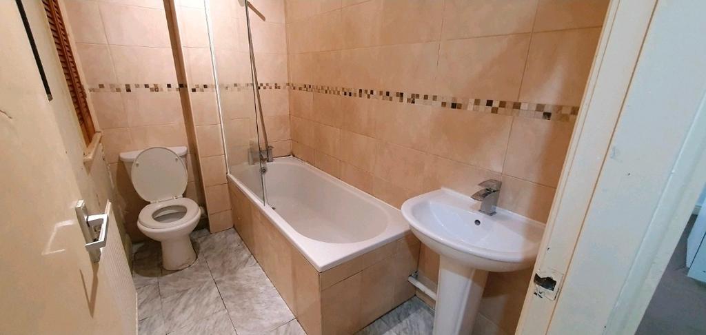 Well-maintained bathroom with a bathtub and ove...