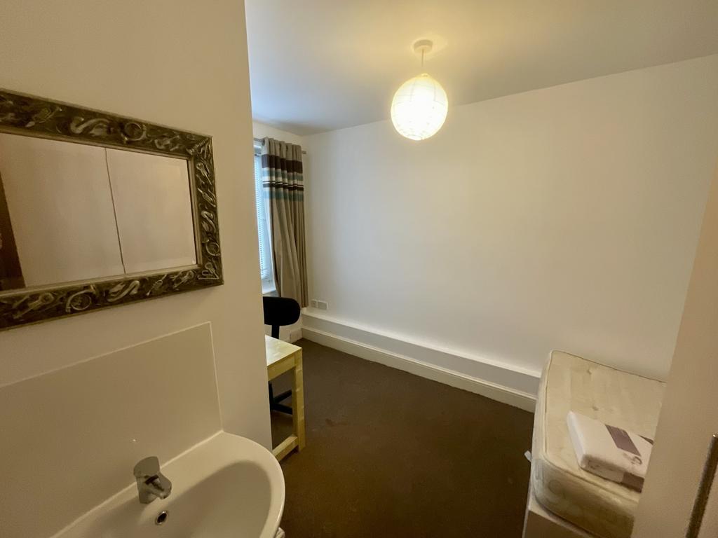 A well-maintained bathroom with a large bathtub...