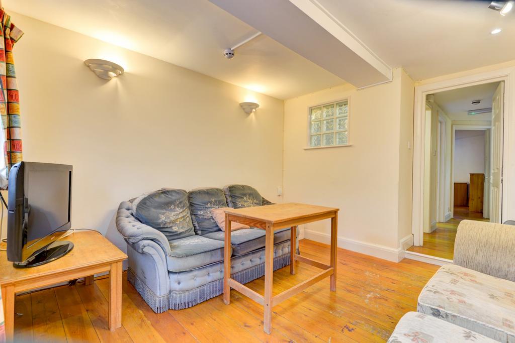 A bright and welcoming living room featuring co...