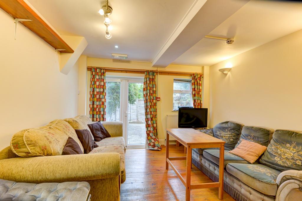 Bright, comfy lounge with two sofas, coffee tab...