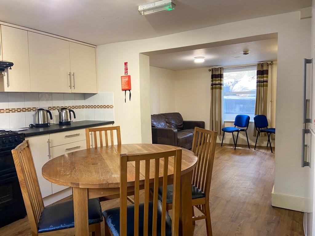 Bright open-plan kitchen and dining area with a...