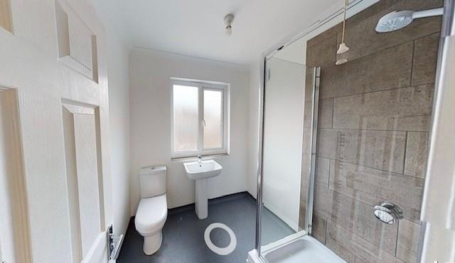 Bright modern bathroom with a walk-in shower, c...