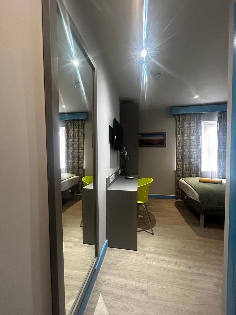 Bright, modern single bedroom with wood-effect ...