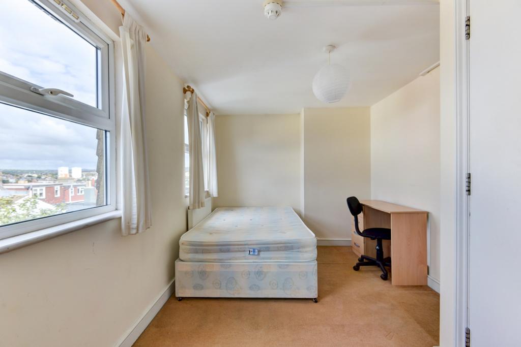 Bright, neatly presented bedroom with a large w...