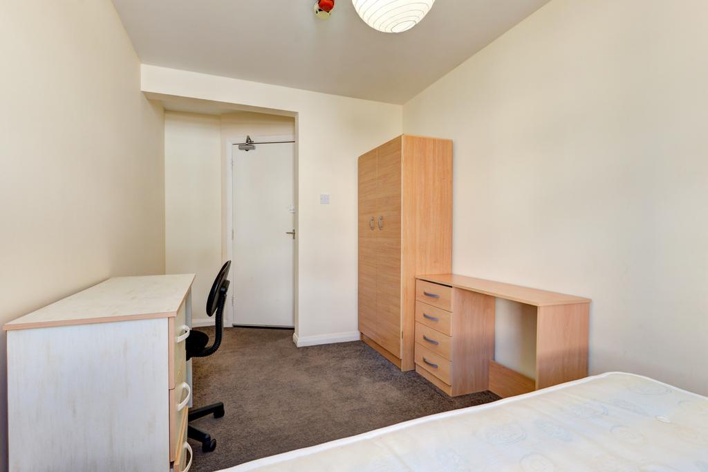 Neat single bedroom with a white-painted interi...