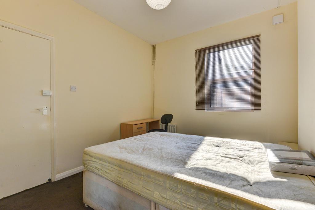 Simple, bright bedroom with a large window brin...