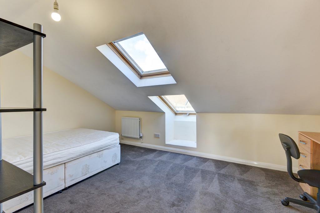 A bright, tidy bedroom with ample natural light...