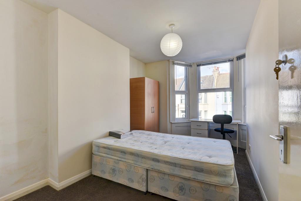 A well-lit double bedroom featuring a standard ...