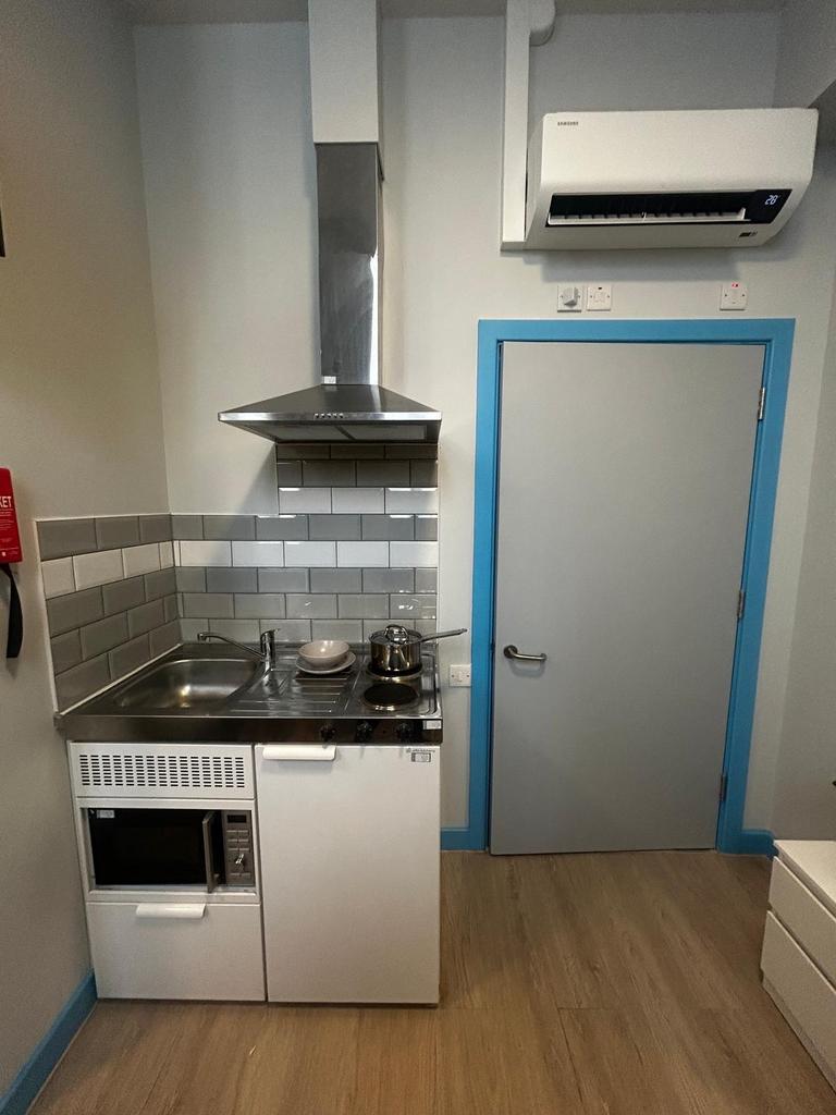 Compact kitchenette with stainless steel sink, ...