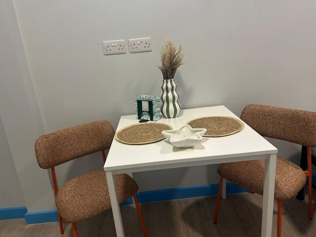 Cozy dining nook with a compact white table, tw...