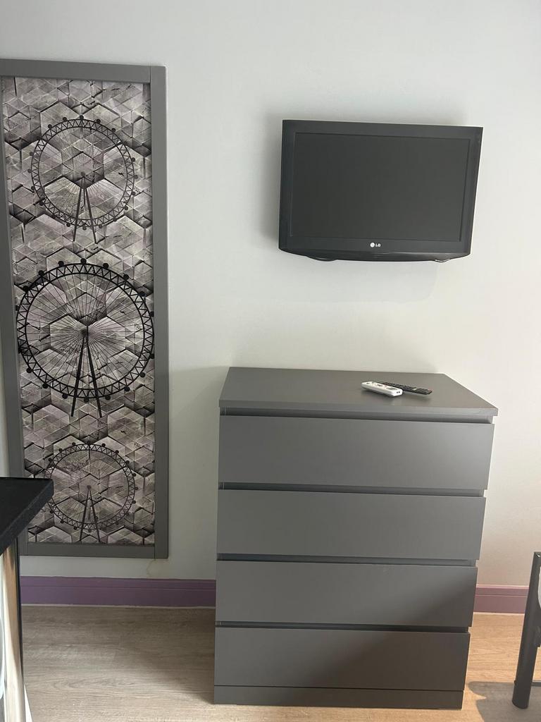 Contemporary bedroom corner with a sleek grey c...