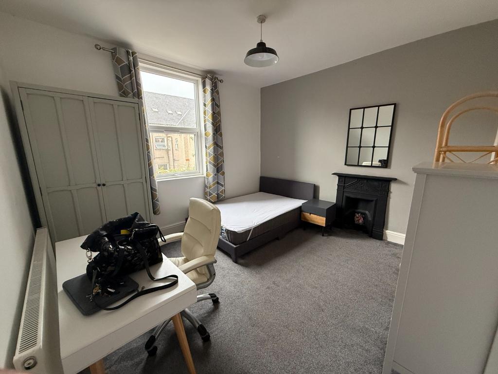 Bright, neutrally decorated double bedroom with...