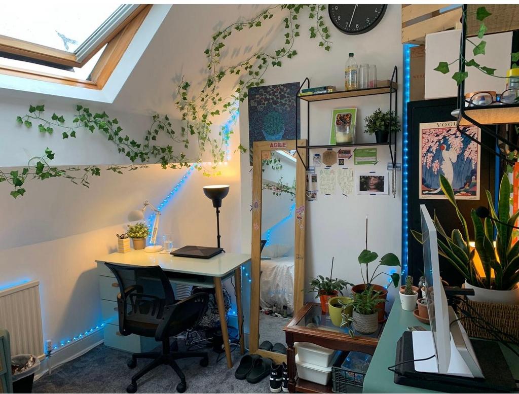 Bright, stylish attic bedroom with a skylight, ...