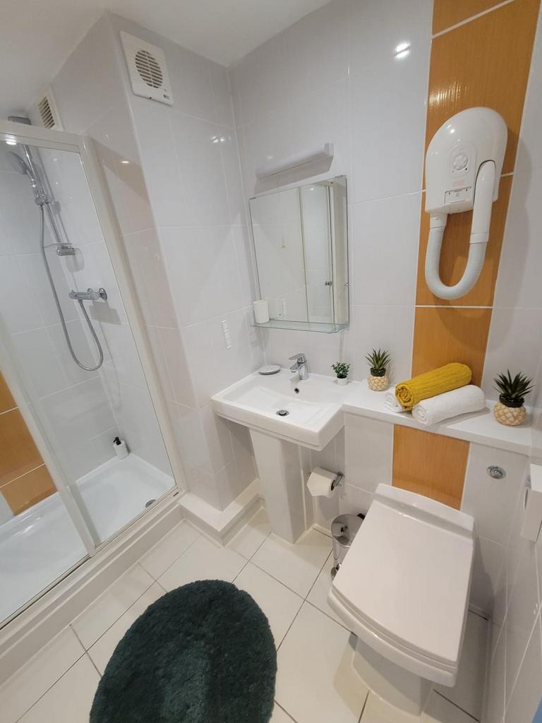 Bright, modern bathroom with a walk-in shower, ...