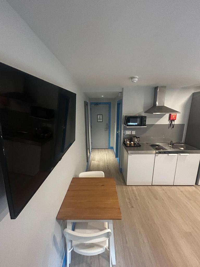 Modern studio kitchenette with a compact dining...