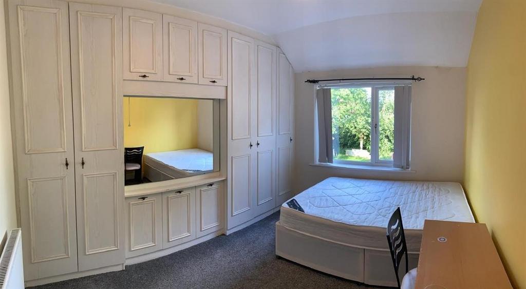 Bright, neatly presented bedroom with built-in ...
