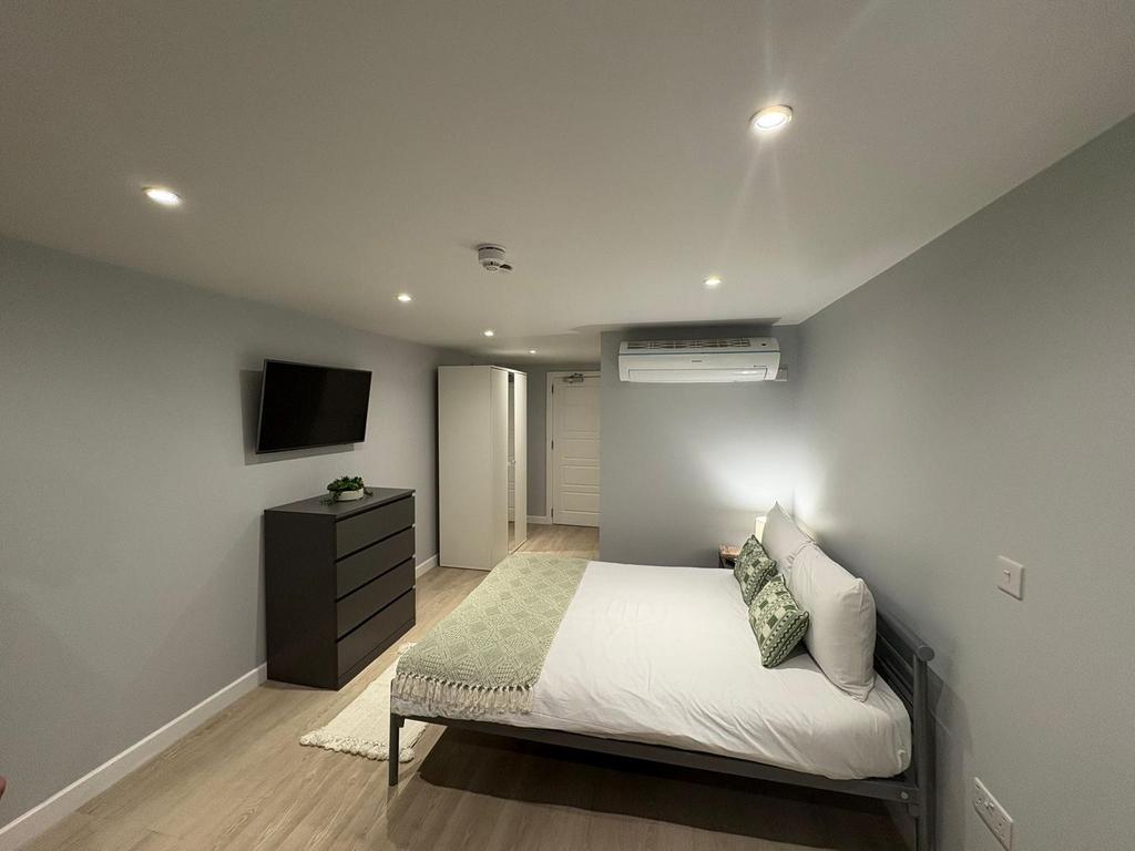 Modern, neatly presented bedroom with a comfort...